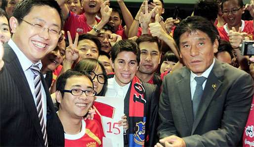 Die Fans von Guangzhou Evergrande empfangen Dario Conca (M.). Links: Präsident Liu Yongzhuo 